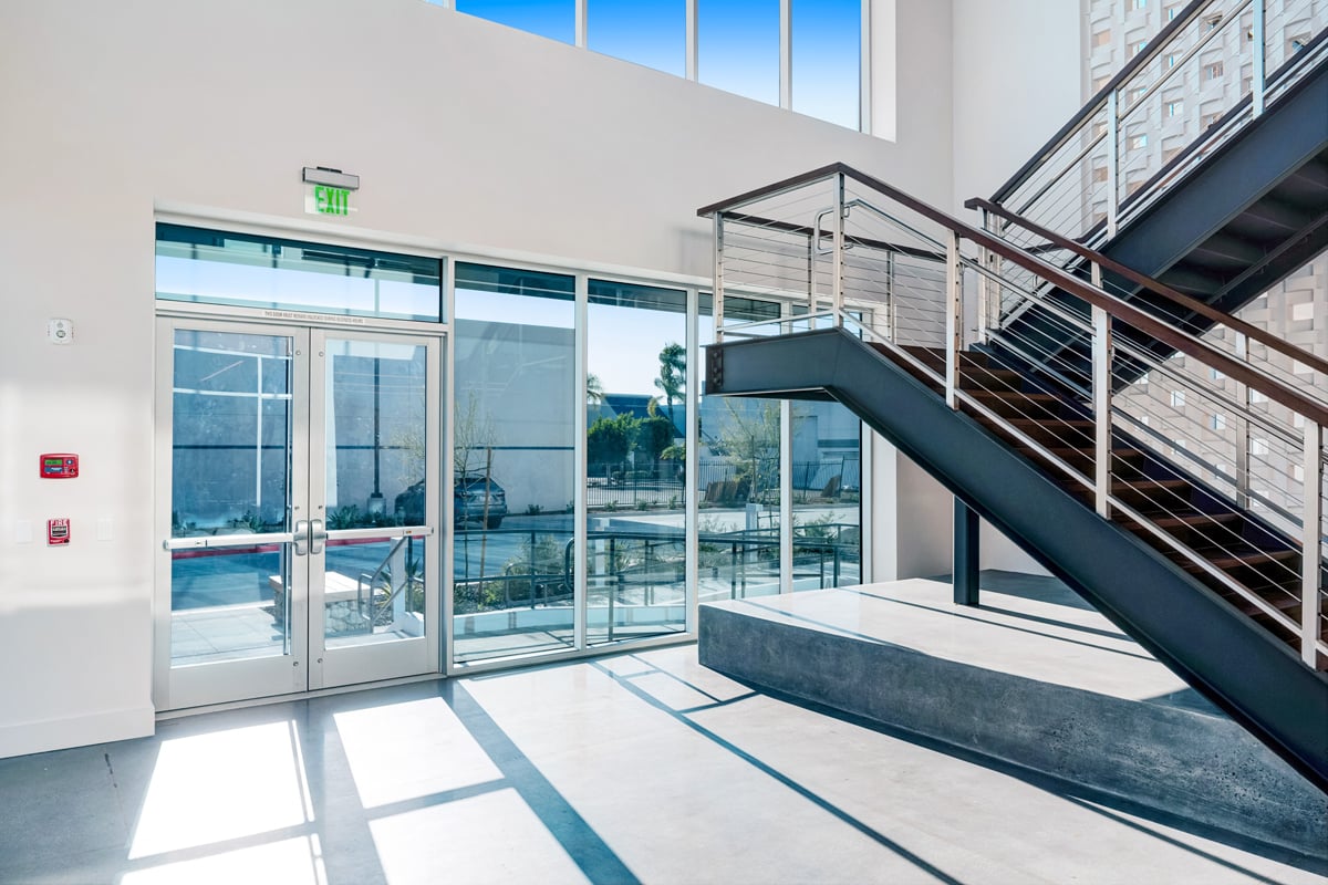 Modern office lobby with stairway and glass walls at 5235 E Hunter Ave